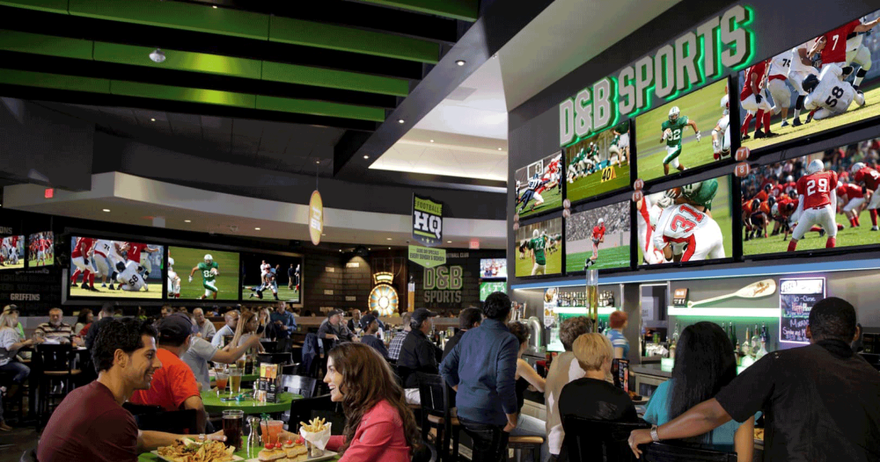 Customers eating and watching sports on television in a gaming and easting establishment
