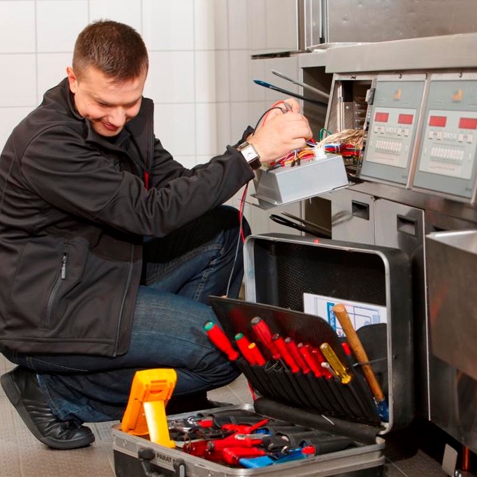 Technician applies a testing tool to a fryer controller