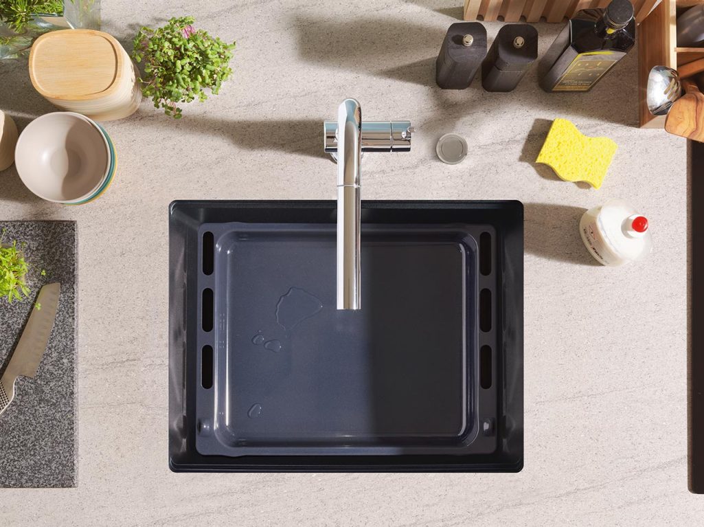 Topdown view of a Franke Maris with a large cooking sheet in it demonstrating the large capacity of the sink