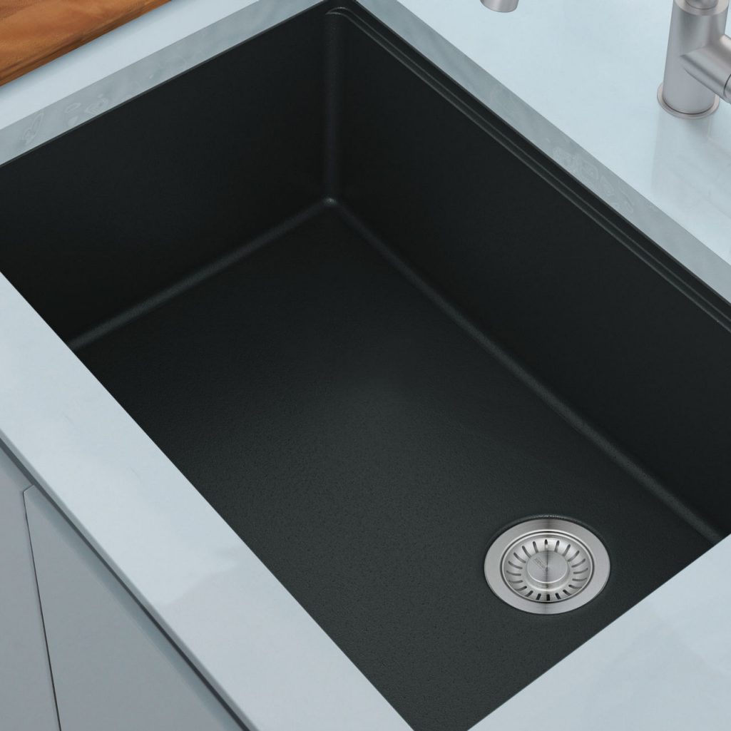 Close up matte black undermount granite sink in a quartz countertop