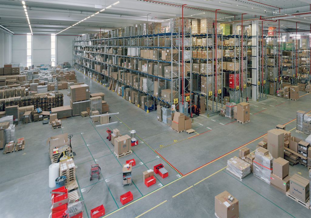 Large Franke warehouse shows staging area in front of five-high racks of equipment 