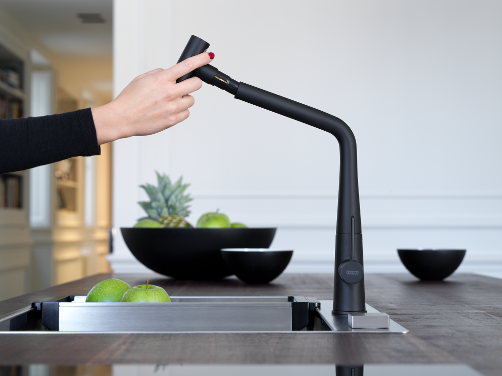 Woman operating the Icon Pull Out Spray Tap
