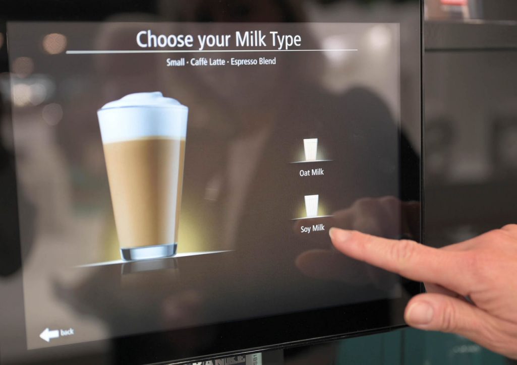 Franke Coffee Systems, coffee machine screen close-up with finger, milk choice