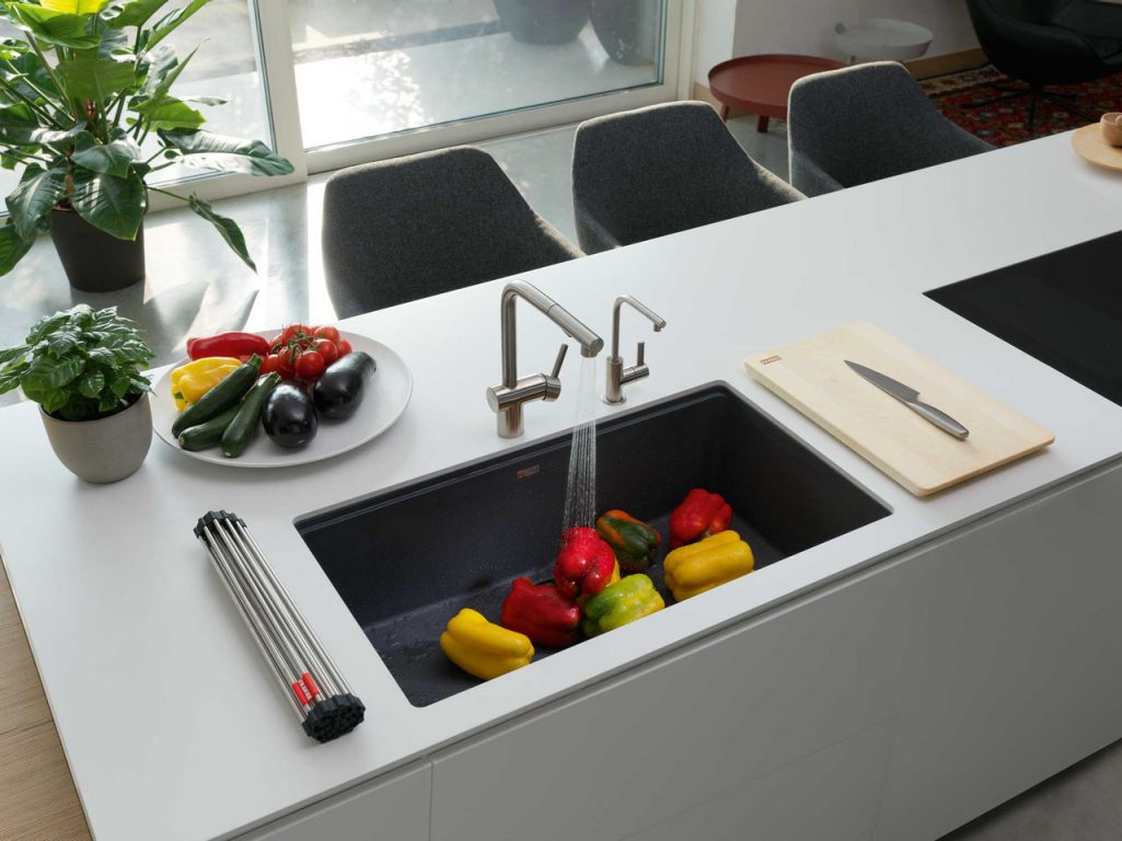Matte black undermount granite sink with sink accessories and a matte black faucet