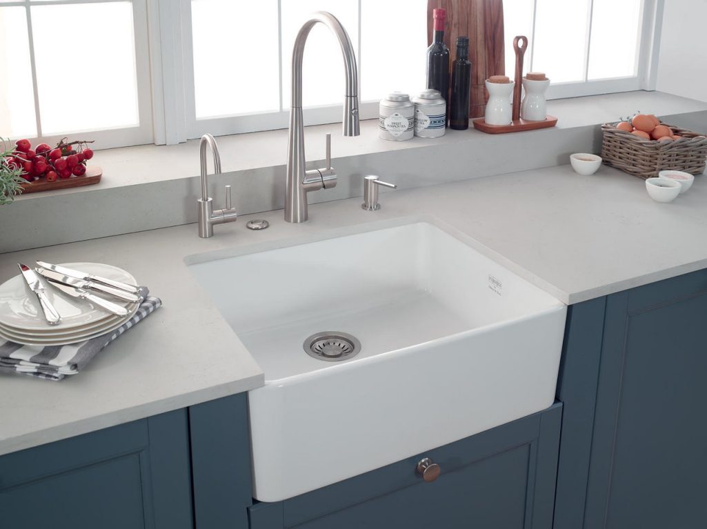 farmhouse kitchen with white apron front sink and chrome faucets