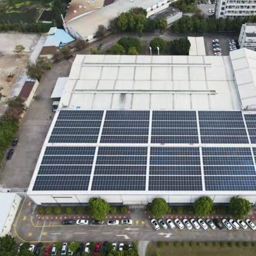 areal view of solar panels on a factory roof